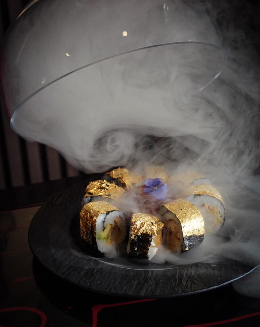 Tokyo Gold Roll with 24K gold leaf revealed under a glass dome with dramatic smoke.